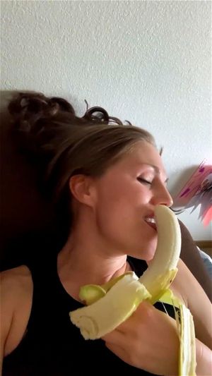 Anastasia sucks a banana